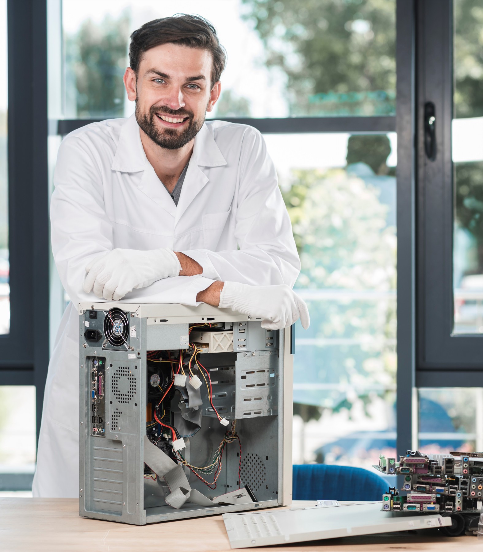 happy-technician-with-broken-computer